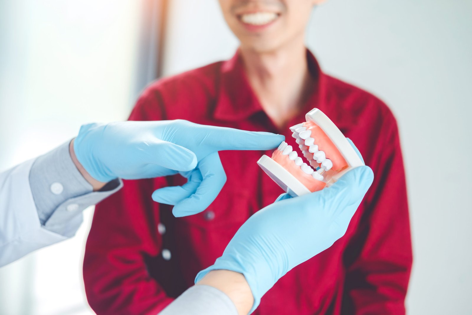 Denturist Showing Dentures to Patient