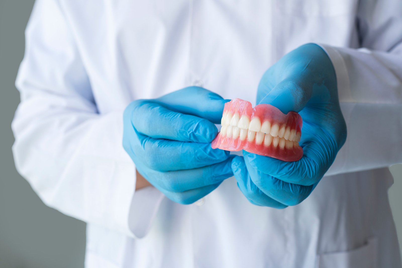 Dentist Holding Teeth Denture