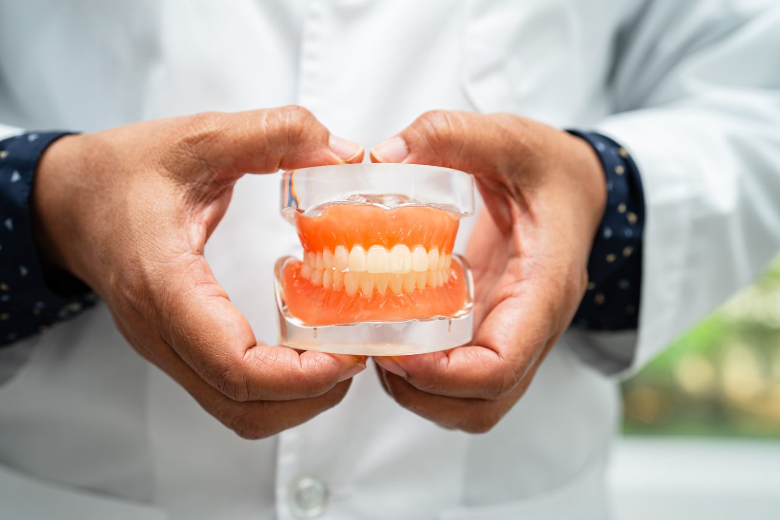 Denturist Holding Dentures