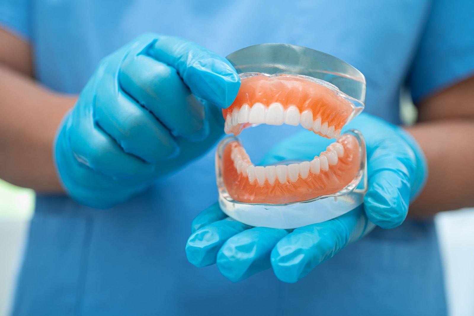 Denture-Design-Pocatello-3 Dentist Holding Dentures