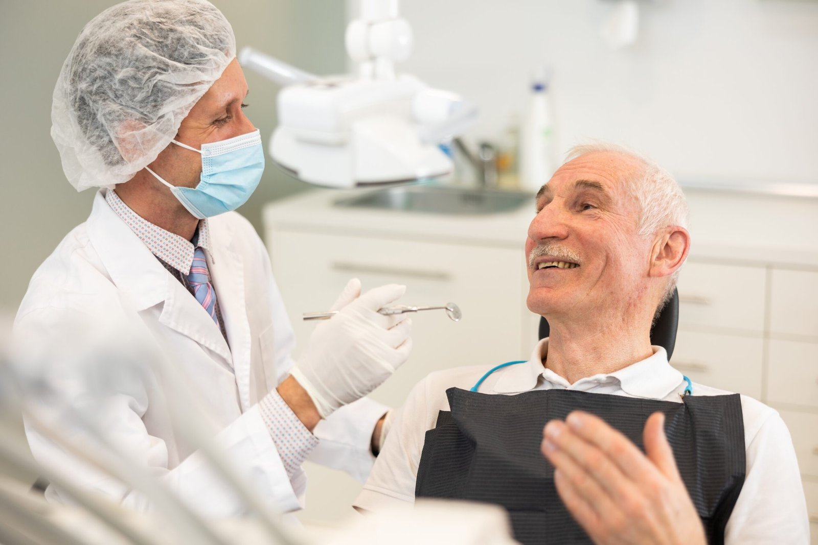 Patient and Denturist Smiling at Each Other